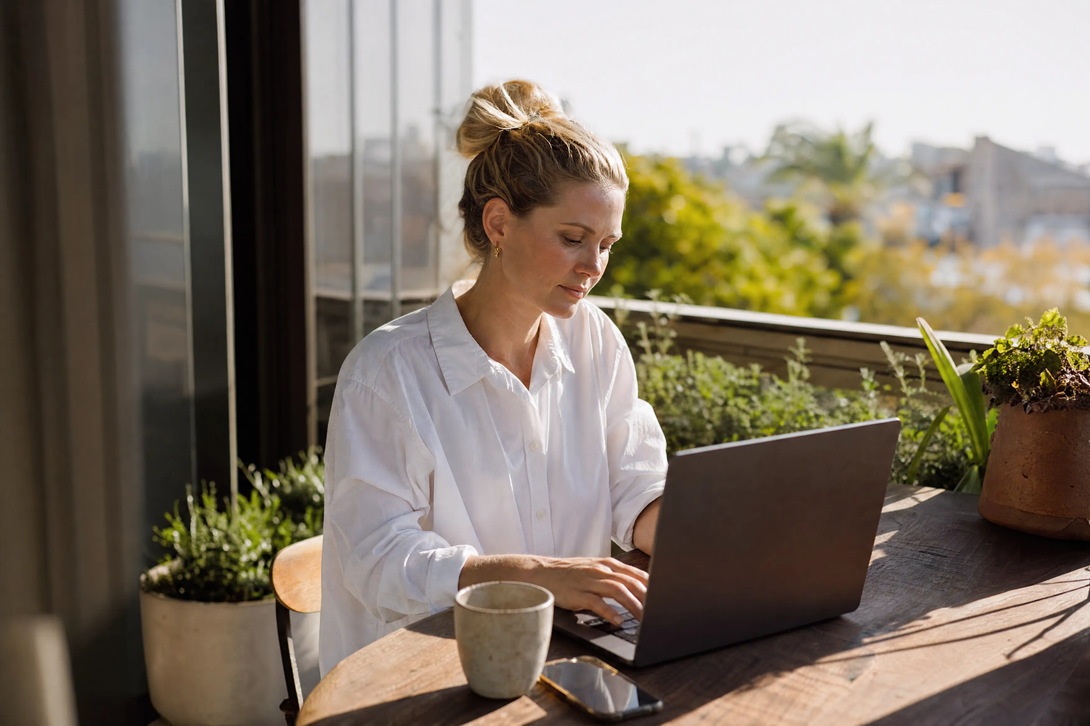 Owner working through plans on her balcony